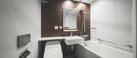 A modern bathroom with a toilet, sink, and bathtub.
