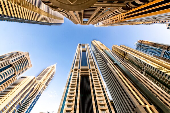 Un edificio de gran altura con un elemento vertical central y varios balcones.