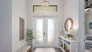 Un couloir moderne avec un banc, une console blanche agrémentée d’objets décoratifs et un grand miroir.