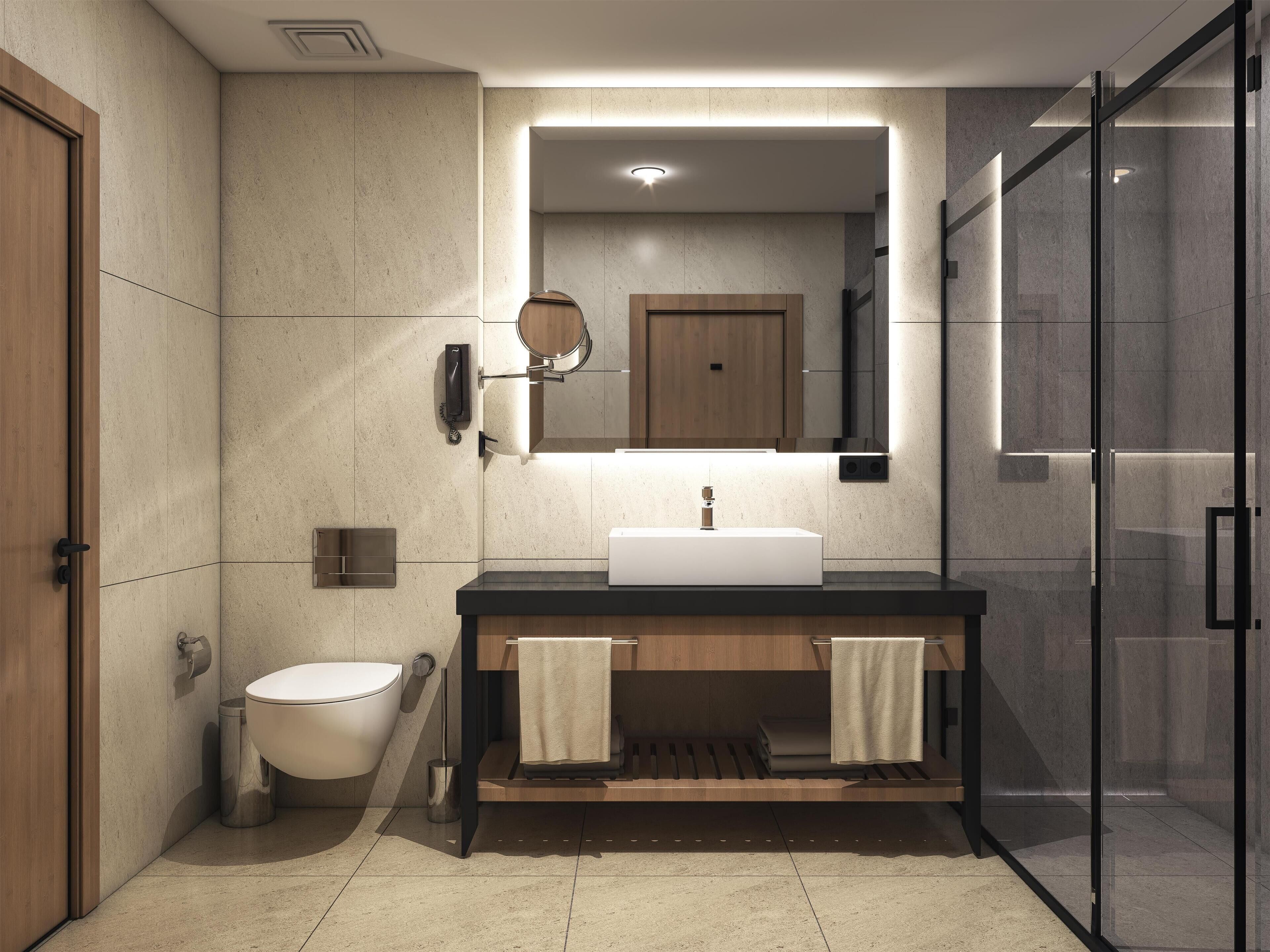 Un baño moderno con inodoro, lavabo y espejo.