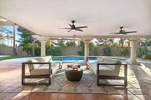 An outdoor patio with two sofas, a coffee table, and ceiling fans. - Casa De Sol - McCormick Ranch * 5BR w/ Heated Pool (Scottsdale)