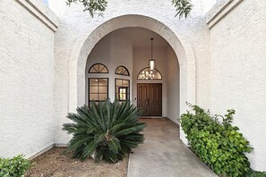 Enter a Mediterranean-inspired haven through the grand arched doorway.