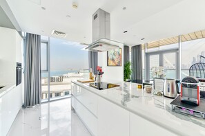 Enjoy a spacious kitchen with a large island and expansive city views from the comfort of this apartment.