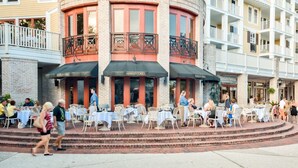 A Marlin Grill restaurant with outdoor seating and a brick facade. - Leah’s Sunset Dreams Studio (Miramar Beach)