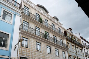 Classic architecture with ornate balconies and patterned tile design.