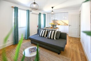 Relax in a cozy living area with a sofa, coffee table, and vibrant rug.