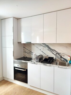 Enjoy cooking in this well-equipped kitchen with oven, stovetop, and sink.