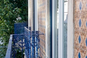 A building facade with ornate metal railings and patterned tilework. - Her Majesty at Liverdade Avenue 1E (Lisbon)