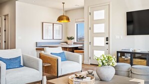A modern living room with two sofas, a coffee table, and a TV. - A Bit of Paradise: Desert Color Lagoon + Beaches (St George)
