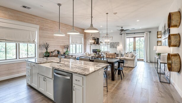 A spacious kitchen with a central island, pendant lights, and a dishwasher. - Residence Club Unit 6 in Carlton Landing (Carlton Landing)