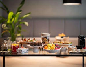 A buffet table with various food items, including pastries, fruits, and beverages. - Radisson Hotel Budapest Budapart (Budapest)