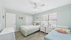 A bedroom with a bed, dresser, nightstand, and a ceiling fan. - Paradise Pointe 137–5 Min to Beach–Sleeps 6 (Panama City Beach)