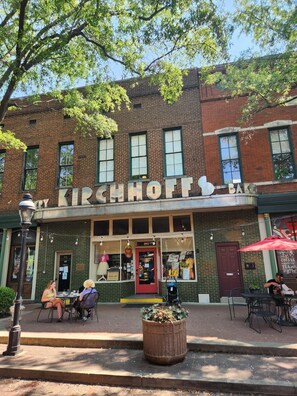 A brick building with a sign reading "Kirschhoff Bar".