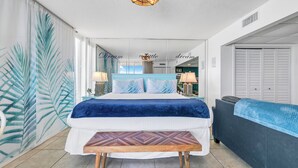 A bedroom with a bed, bedside table, and a view of the hallway. - Sunset views over the Gulf.  Beachside BEST.  The perfect getaway for two!   (Panama City Beach)
