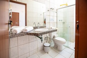A bathroom with a sink, toilet, and shower.