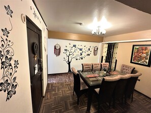 Enjoy meals in this stylish dining area with a glass-top table and tufted chairs.