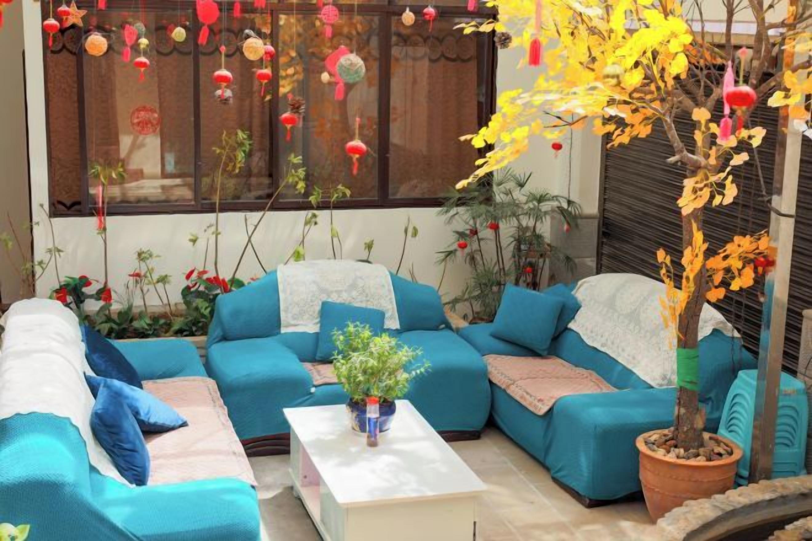 A cozy seating area with a sectional sofa, a coffee table, and a potted plant.