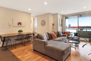 Una sala moderna con sofá, mesa de centro y comedor.