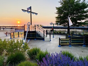 A park with exercise equipment, a flag, and a sunset view. - Large Beach House! 4 King beds! Great location! (South Haven)