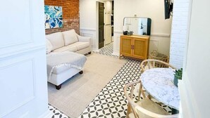 A compact living space with a sofa, a dining table, and a cabinet.