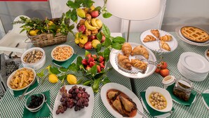 A table set with various fruits, pastries, and condiments, suggesting a breakfast or snack setting. - Hotel Vecchie Mura  (Finale Ligure)
