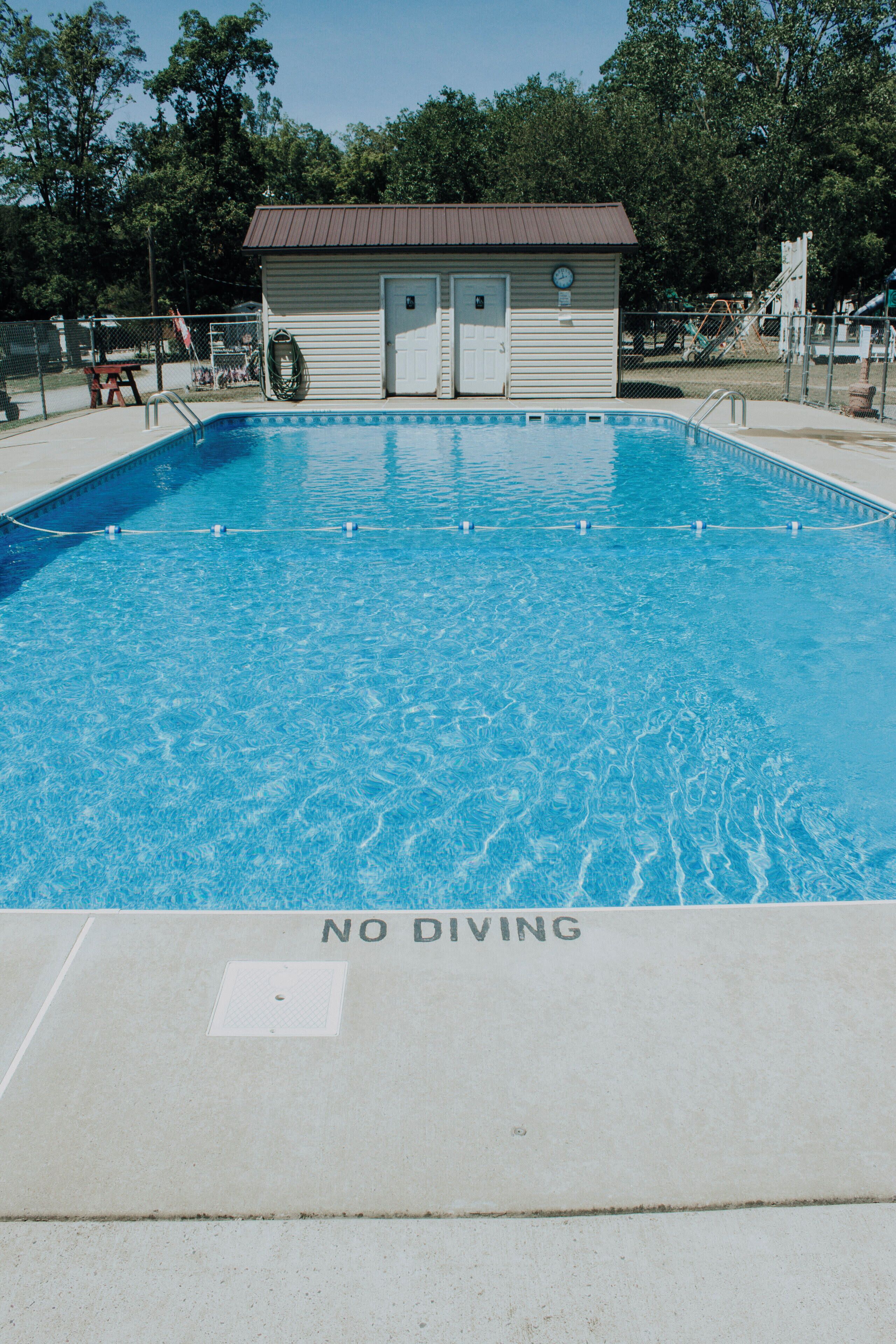 A swimming pool with a 'NO DIVING' sign at the bottom.