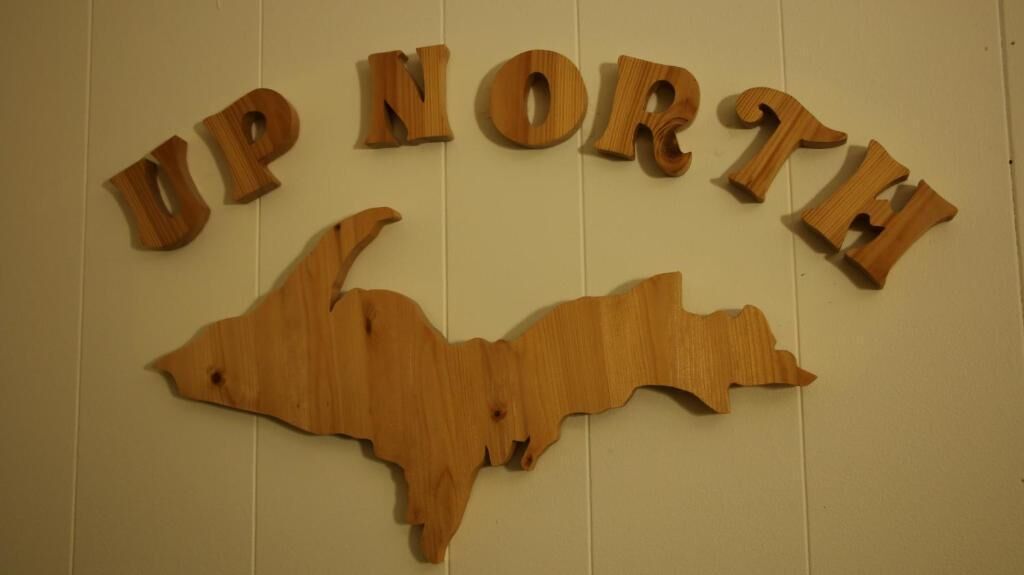 A wooden sign with the text "UP NORTH" and a bear silhouette.