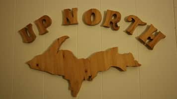 A wooden sign with the text "UP NORTH" and a bear silhouette.