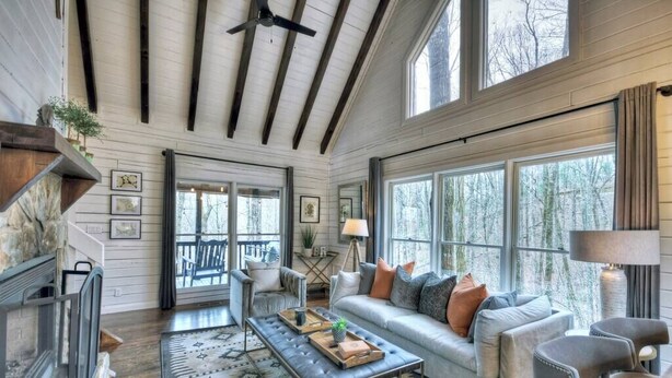 A spacious living room with a large window, a fireplace, and a cozy seating area. - Picture Perfect | $179 Off Your Stay! (Blue Ridge)