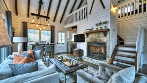 A spacious living room with a fireplace, wooden beams, and a comfortable seating area. - Picture Perfect | $179 Off Your Stay! (Blue Ridge)
