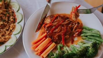 A plate of food with meat, vegetables, and a fork.