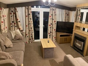 Relax in style with a comfortable sofa set, flat-screen TV, and cozy fireplace.