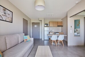 Un apartamento moderno con sala de estar, kitchenette y comedor.