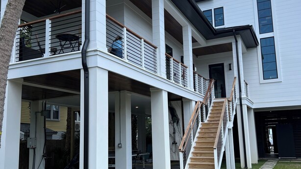 A modern two-story house with a covered patio, a staircase, and a well-maintained lawn. - Suite A - 3 minutes walk to Center of Folly Beach, across from beach-1 Room (Folly Beach)