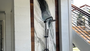 A modern shower enclosure with a marble backsplash and a wooden ceiling. - Suite A - 3 minutes walk to Center of Folly Beach, across from beach-1 Room (Folly Beach)
