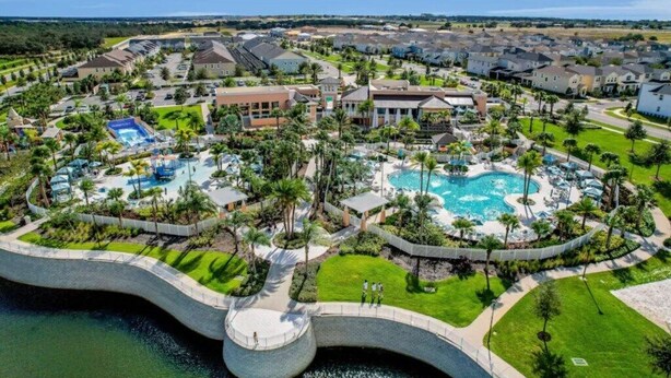 A resort with multiple swimming pools, lush landscaping, and a variety of building styles.