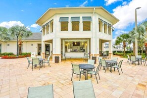 Guests can dine or relax in the patio area, surrounded by lush greenery.