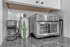A kitchen with a coffee maker, a cactus-shaped mug, and a built-in oven. - Enjoy The City of Good Neighbors in Centrally Located + Beautiful Buffalo Dream (Buffalo)