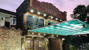 A building with a stone facade, a sign reading "Mikayla Resort," and a covered outdoor area with a glass roof. - Mikayla Resort (Chilaw)