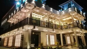 A multi-story building with a modern architectural design, featuring balconies and large windows. - Mikayla Resort (Chilaw)