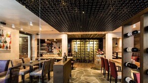 A modern interior with a wine cellar, stone flooring, and a bar area. - Luxury 1BR Condo in Silicon Valley's Heart (Menlo Park)