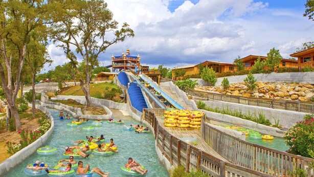 Un parc aquatique doté d’un grand toboggan aquatique, de plusieurs pistes aquatiques et de bouées gonflables.