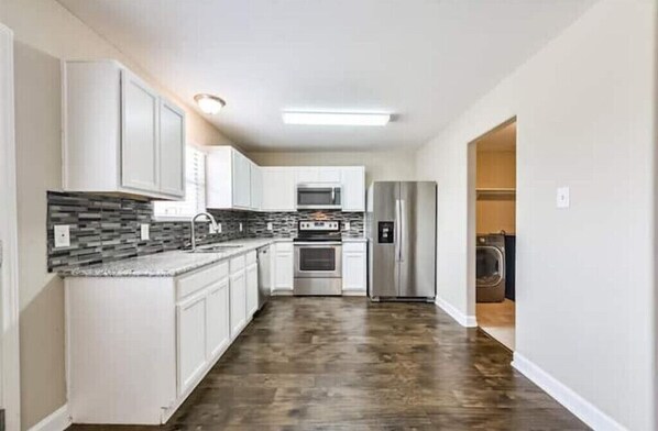 Enjoy cooking in this well-equipped kitchen with a refrigerator, oven, and microwave.