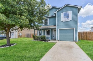 Stroll up to this charming home, featuring a front porch, garage, and beautifully manicured lawn.