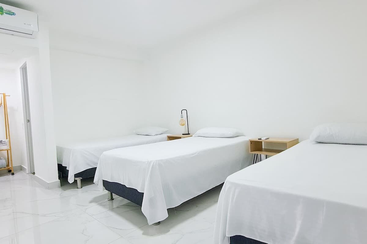 deluxe triple room | egyptian cotton sheets, premium bedding, down duvets, memory-foam beds