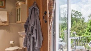 A bathroom with a toilet, a sink, and a towel rack.