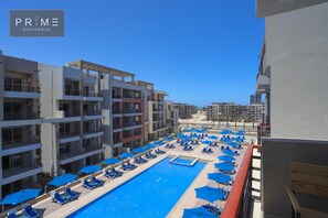 Seasonal outdoor pool, open 8:00 AM to 8:00 PM, pool umbrellas