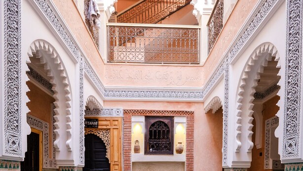 A courtyard with a swimming pool, ornate arches, and a wooden door labeled "ITSNANE". - Riad Minami (Marrakech)