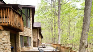 A hot tub on a wooden deck with a stone building in the background. - Game room, Complete Retreat, Stonehaven (Morgantown)