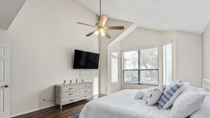 A bedroom with a bed, a ceiling fan, a TV, a dresser, and a window with blinds. - 4 Bedroom Incredible Backyard with Pool! (Glendale)